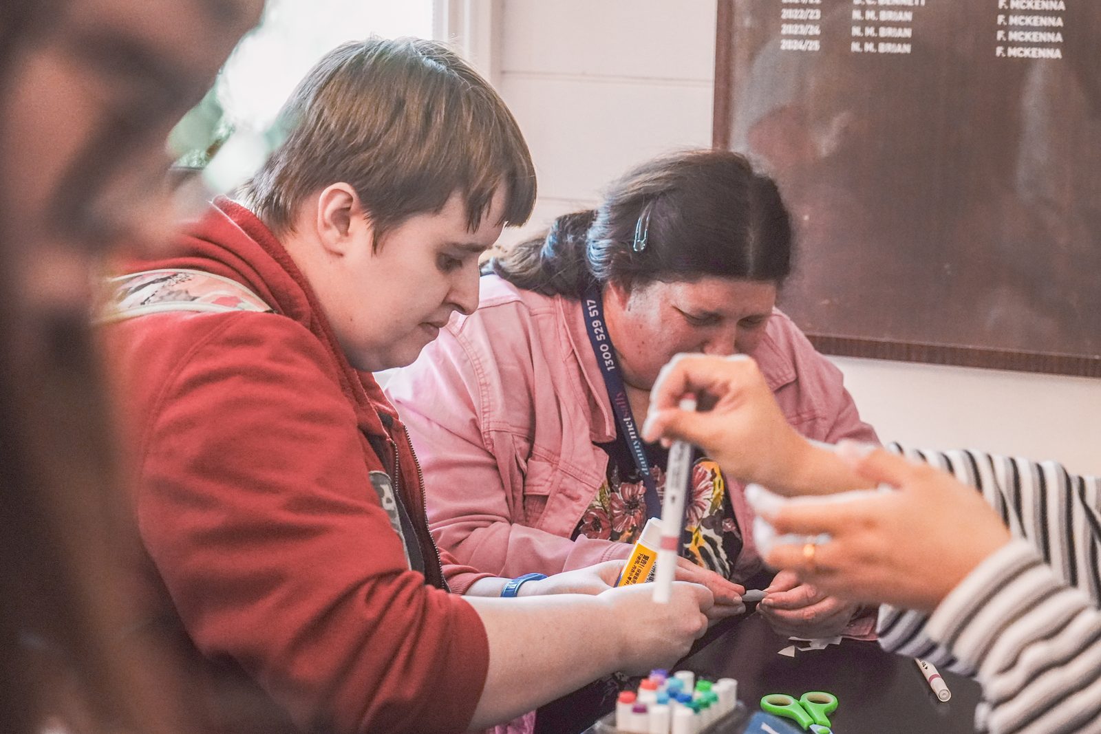 Hands at one of the craft activity tables