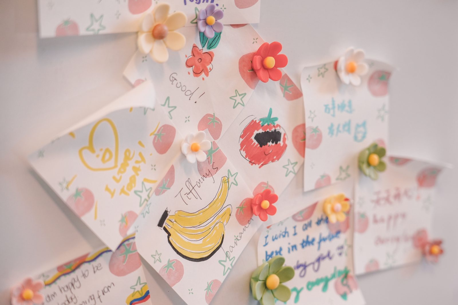 Handwritten wishes and drawings pinned to the message board